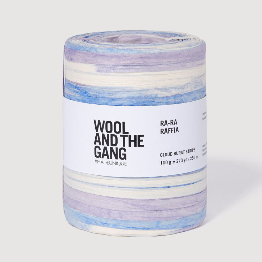 Spool of blue, purple, and white yarn with a label on a white background