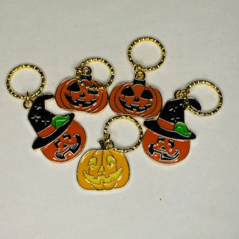 Pumpkin heads of 3 designs in varying oranges, one design with a witches hat.