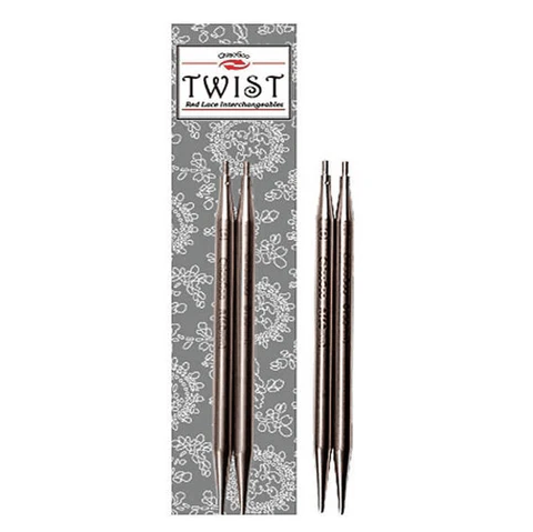 Pair of metal knitting needles with decorative packaging featuring floral patterns on a white background.