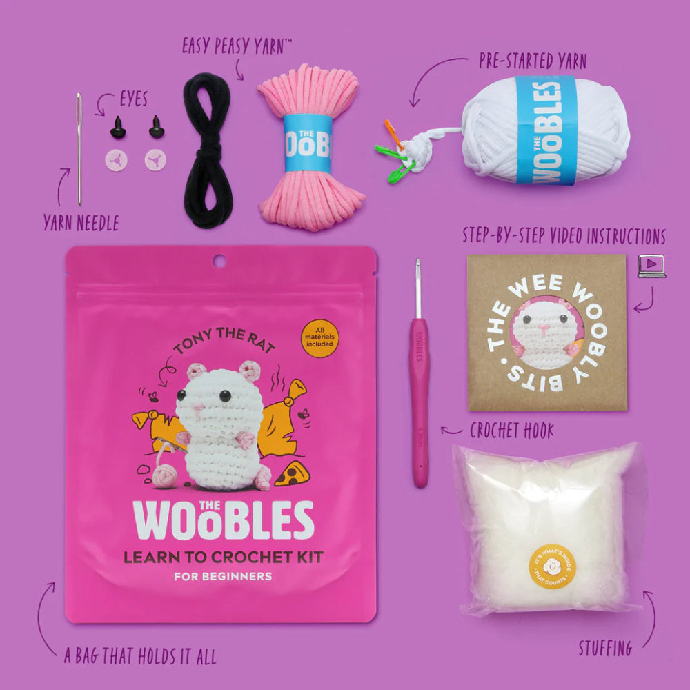 Crochet kit with various items on a purple background, including yarn, a hook, and a bag labeled 'The Woobles'.