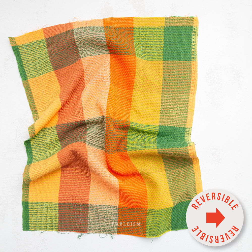 yellow, orange, and green checkered fabric swatch. Says "reversible" on sticker in the front