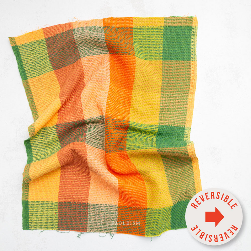 yellow, orange, and green checkered fabric swatch. Says "reversible" on sticker in the front