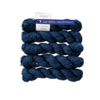 Five skeins of blue yarn with a label on a white background