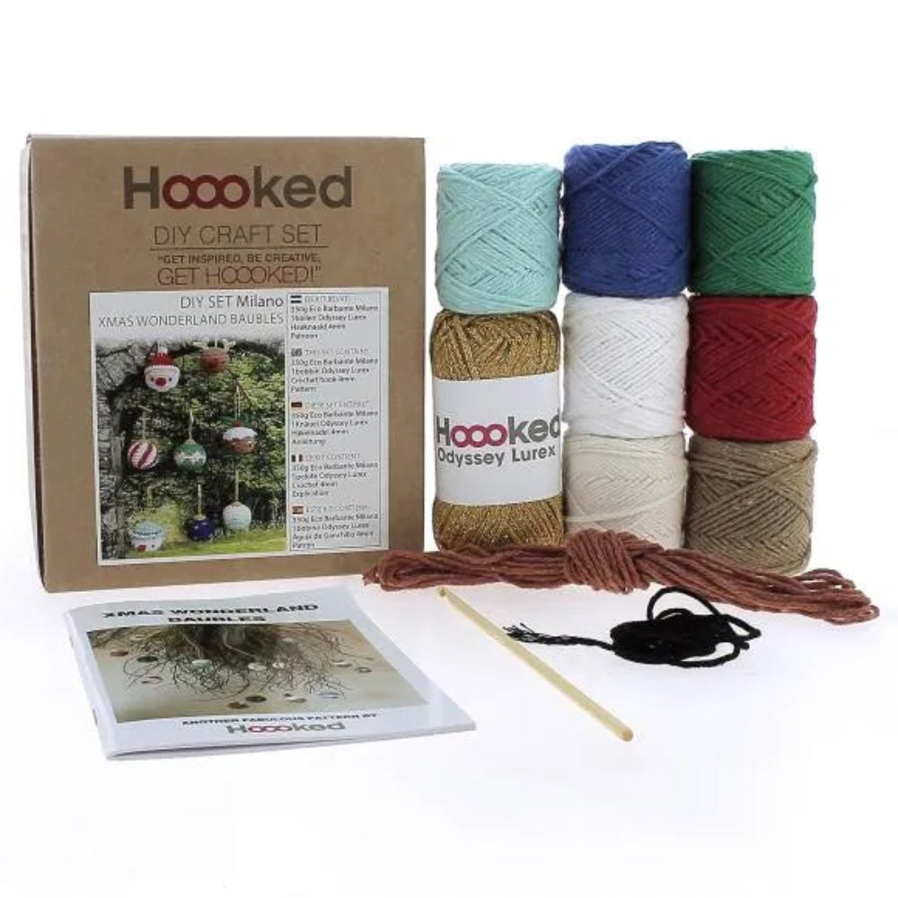 The Crochet Baubles Kit and its contents: a variety of colorful yarn, crochet hook, and instruction booklet