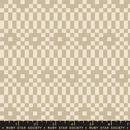 Fabric with a pixelated geometric pattern in beige and tan.