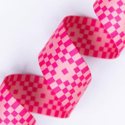 Pink and red checkered webbing on a white background