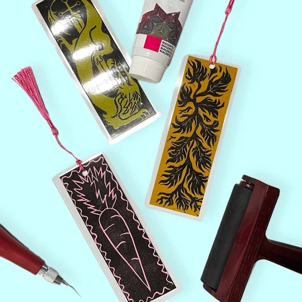 Laminated bookmarks and block printing tools on a blue background