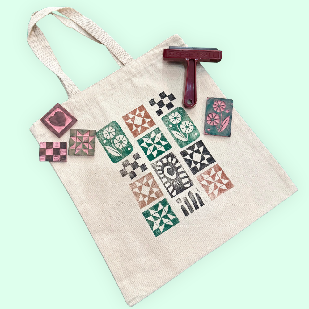 Tote bag with patterned stamps and a roller on a light green background