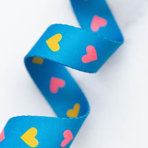 Blue webbing with colorful heart patterns on a white background