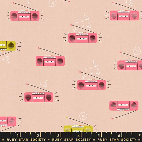 Peach colored fabric featuring illustrated pink and green radios with white music notes.