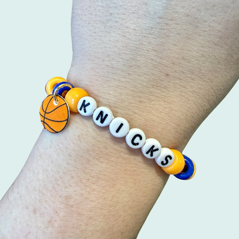 Bracelet with 'Knick' beads on a wrist against a light background