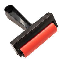 Red and black brayer tool on a white background