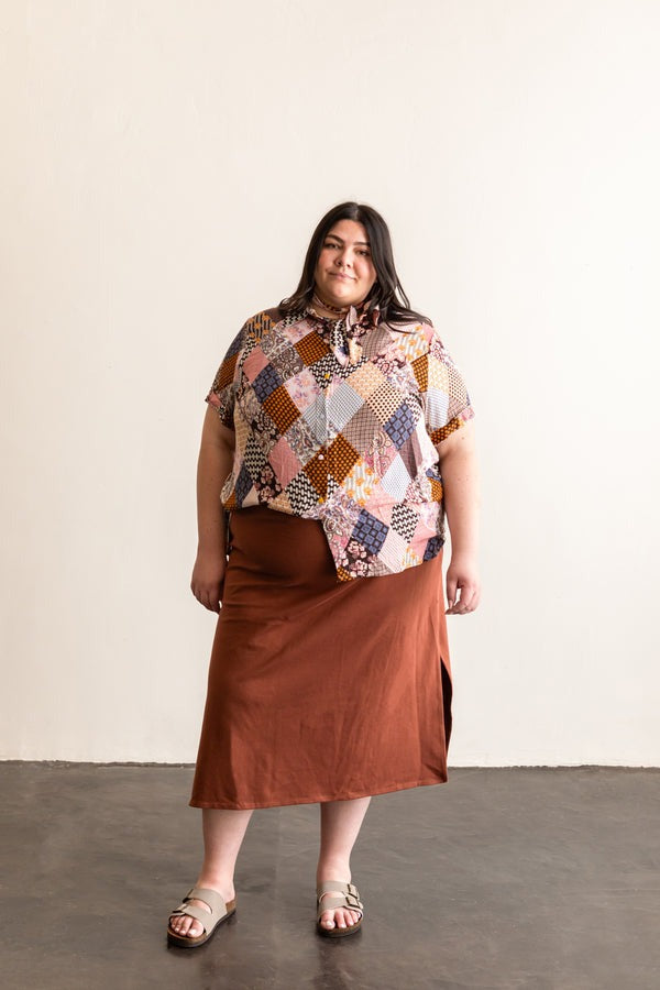 View from the front of a person wearing the short sleeve version of the Butano Button Up in a diamond pattern fabric.