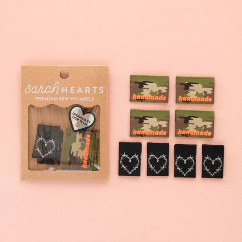 Packaging of 'Sarah Hearts' premium sew-in labels with heart designs and camo on a pink background.