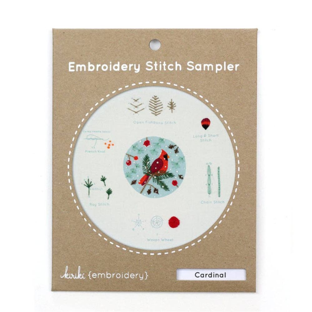 Embroidery stitch sampler with cardinal design on a cardboard backing