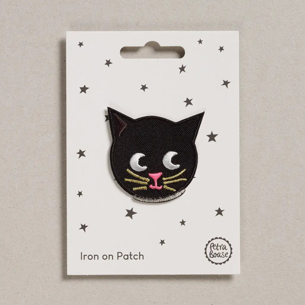 Black cat iron on patch on a white card with star patterns, brand 'Petra Boase' visible.