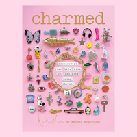 The book "Charmed" by Kelsey Armstrong with a cover featuring many cute charms against a pink background