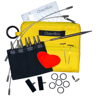Knitting needle set with yellow case, black pouch, and various accessories on a white background