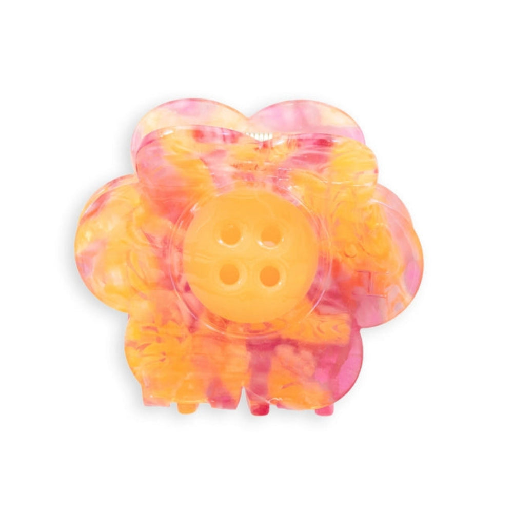 A pink, yellow and orange daisy with a button center claw clip on a white background.
