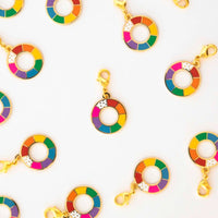 Several zipper charms with color wheels set against a white background. 