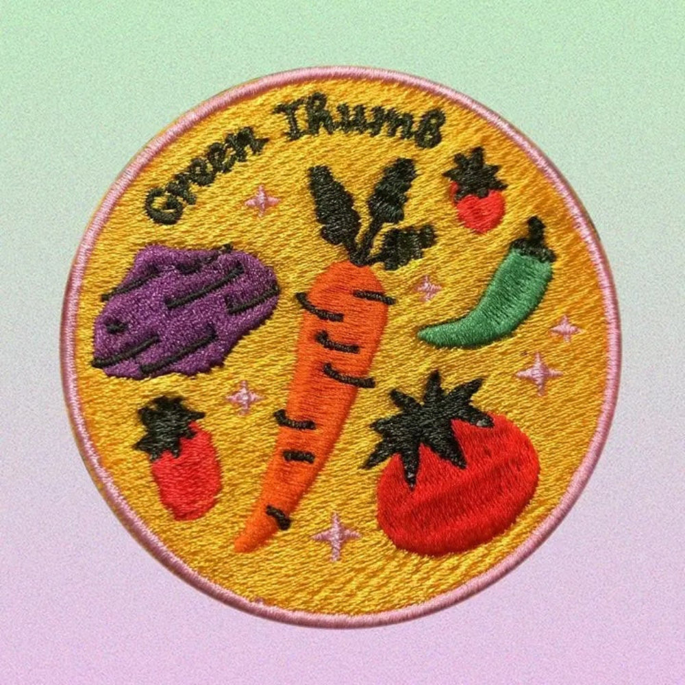 Embroidered patch with vegetables and 'Green Thumb' text on a yellow background