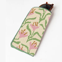 Needlepoint sunglasses case with floral pattern on a white background