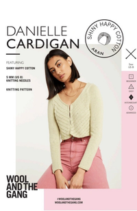 Brunette woman in pink jeans and a textured ream cardigan on a gray, white, and light pink background with Wool and the Gang branding and text.