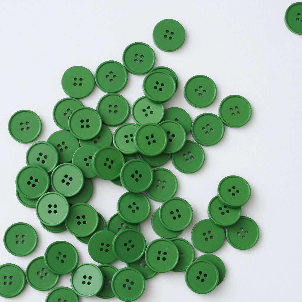 Pile of green buttons on a white background