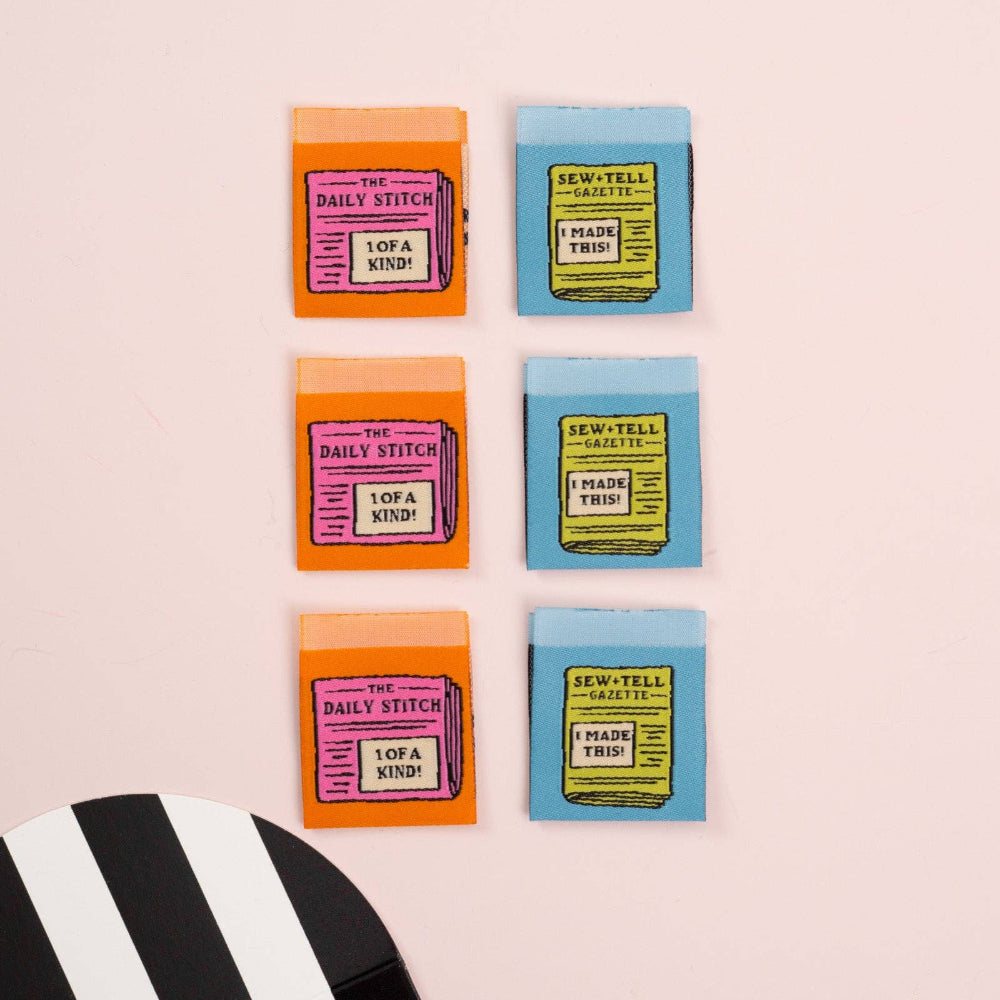 Colorful sewing labels with text labels on a pink background