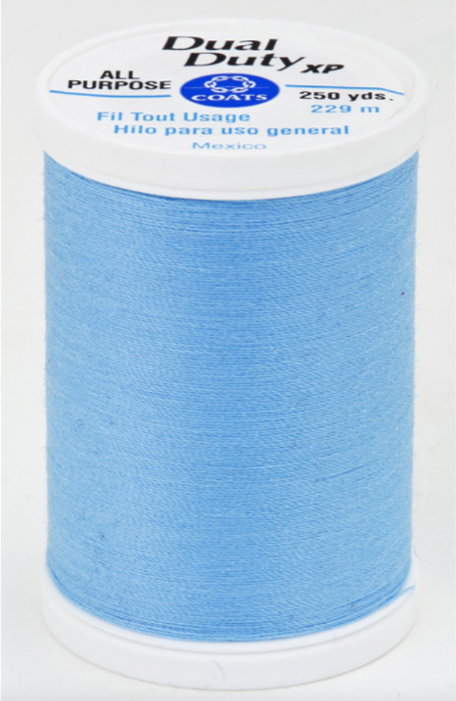 A spool of light blue Dual Duty XP sewing thread with a white label featuring blue and black text, set against a plain white background.