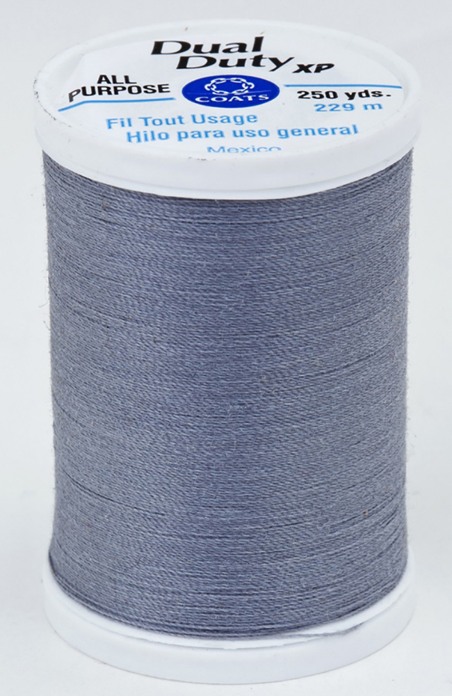 A spool of dark gray Dual Duty XP sewing thread with a white label featuring blue and black text, set against a plain white background.