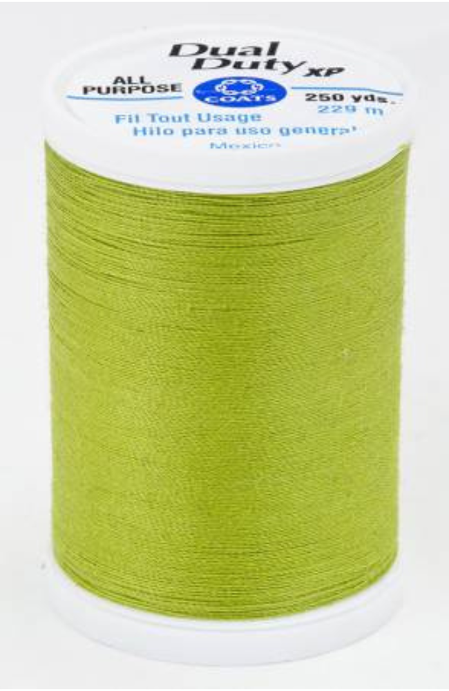 A spool of green Dual Duty XP sewing thread with a white label featuring blue and black text, set against a plain white background.