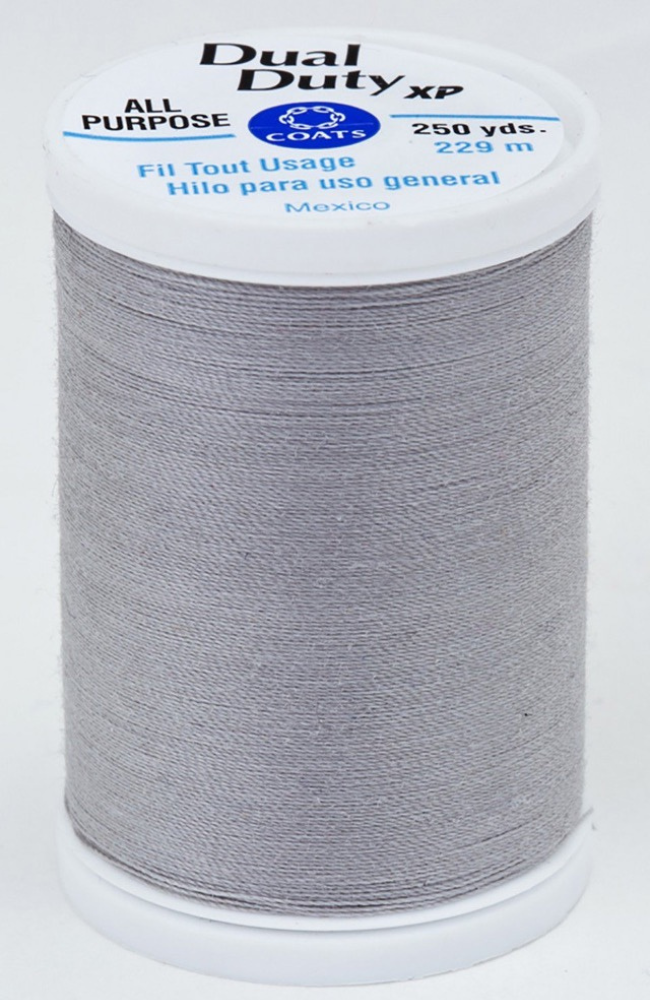 A spool of gray Dual Duty XP sewing thread with a white label featuring blue and black text, set against a plain white background.