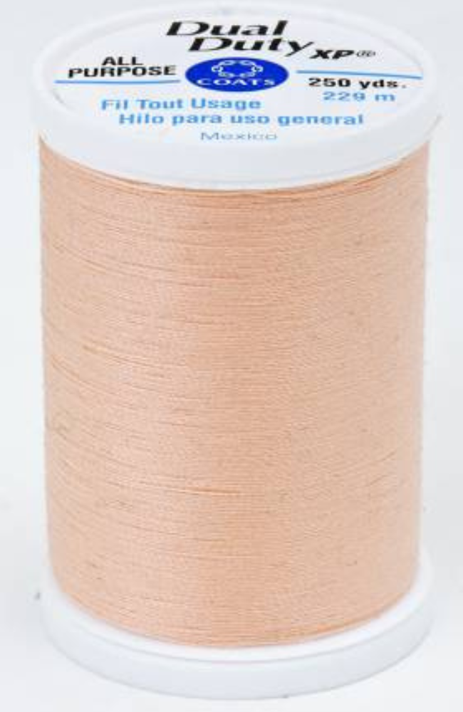 A spool of light orange Dual Duty XP sewing thread with a white label featuring blue and black text, set against a plain white background.