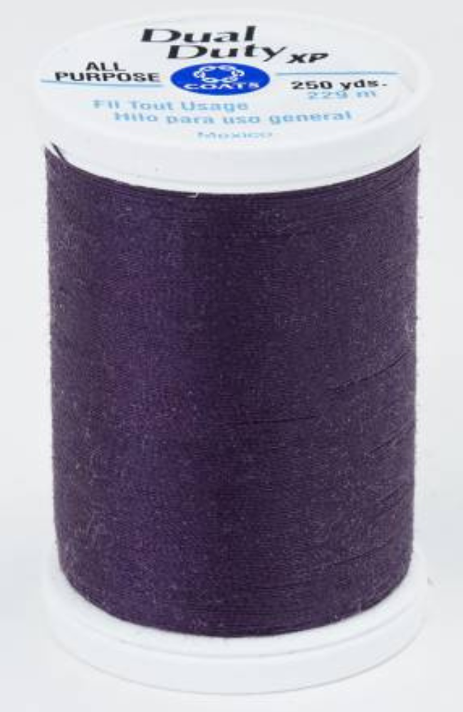A spool of dark purple Dual Duty XP sewing thread with a white label featuring blue and black text, set against a plain white background.