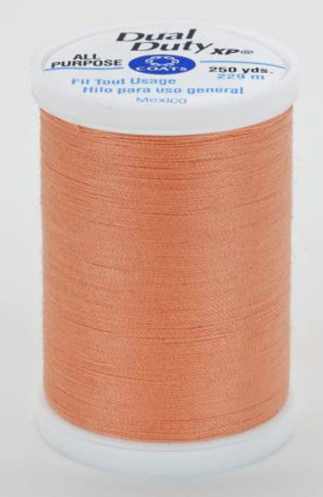A spool of orange Dual Duty XP sewing thread with a white label featuring blue and black text, set against a plain white background.