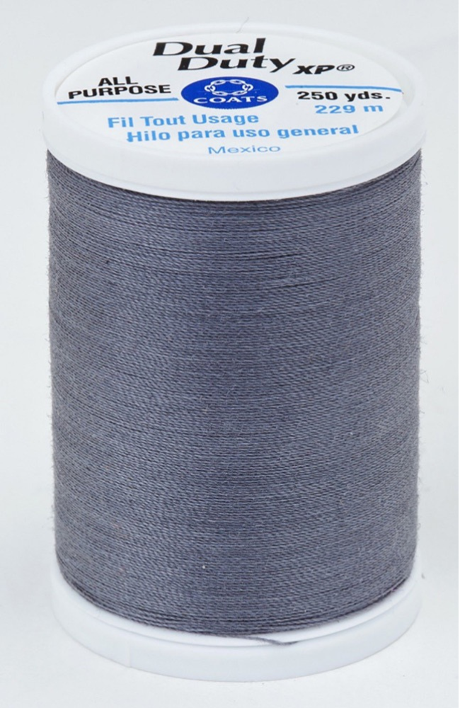 A spool of gray Dual Duty XP sewing thread with a white label featuring blue and black text, set against a plain white background.