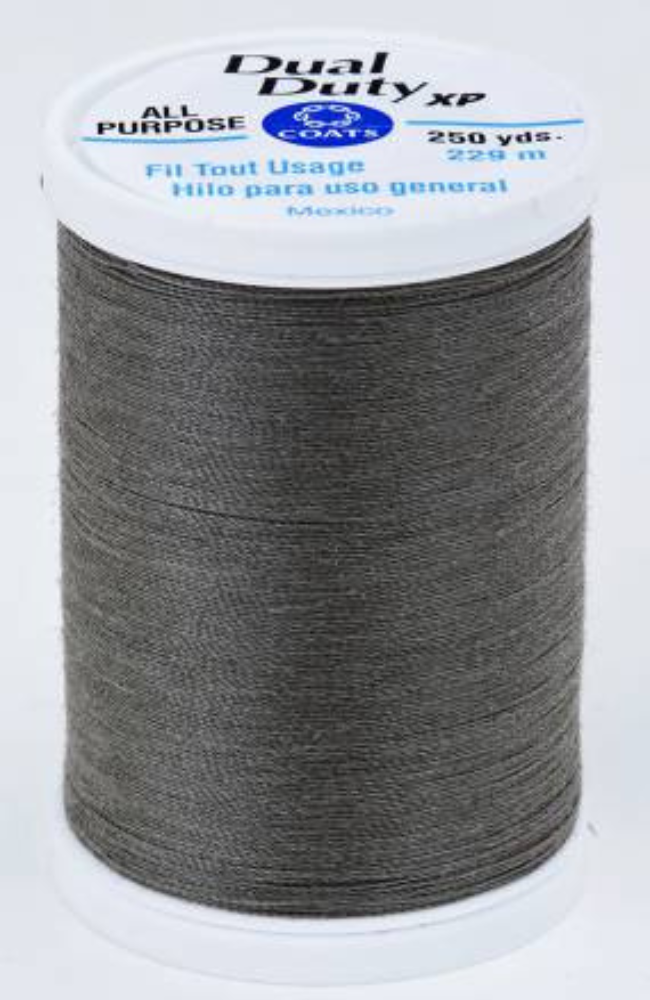 A spool of dark gray Dual Duty XP sewing thread with a white label featuring blue and black text, set against a plain white background.