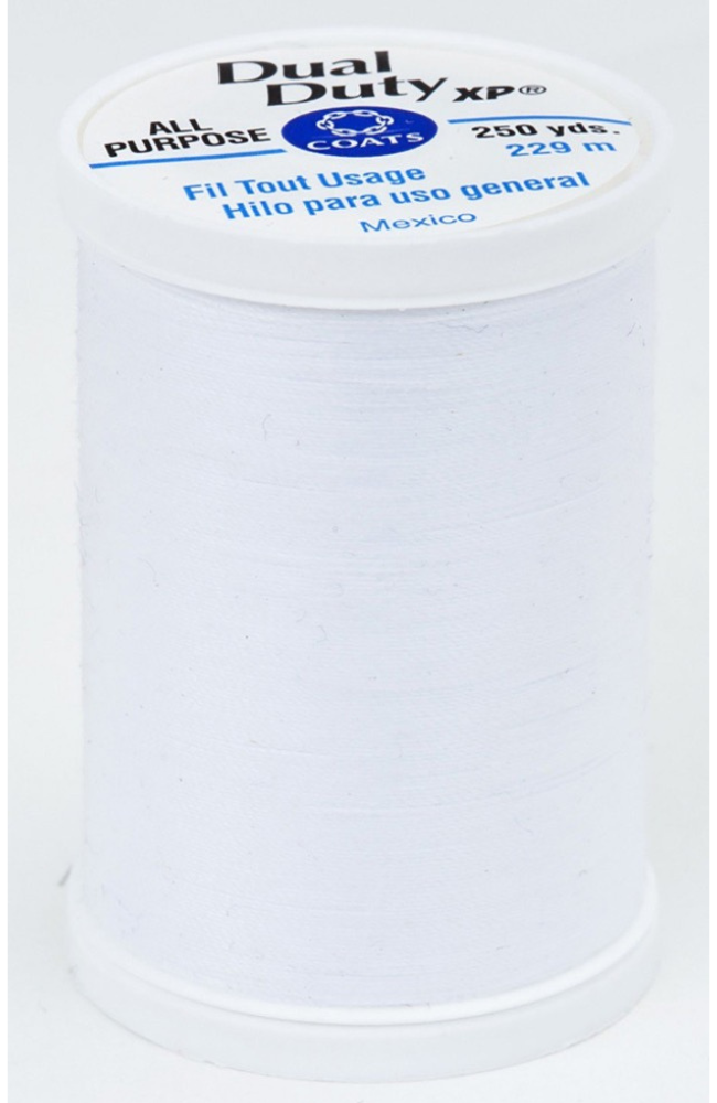A spool of white Dual Duty XP sewing thread with a white label featuring blue and black text, set against a plain white background.