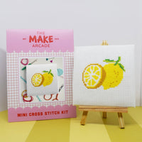 Make Arcade mini cross stitch kit with completed lemon design on a white surface