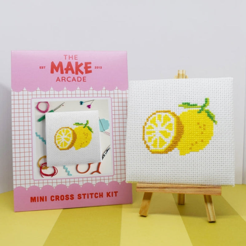 Make Arcade mini cross stitch kit with completed lemon design on a white surface