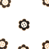 Several black and white daisy button needle minders on a white background.