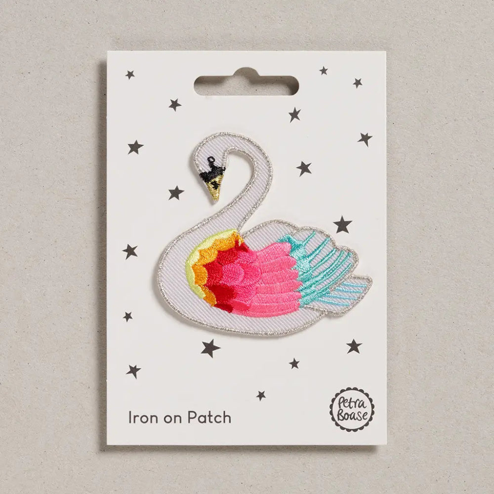 white swan with multicolored wing patch