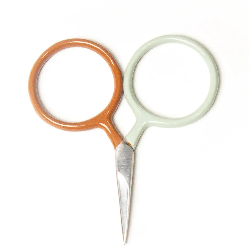Pair of small scissors with orange and green handles on a white background