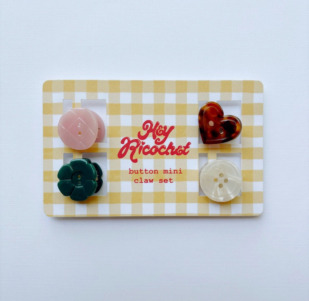 A set of five mini button clips, displayed on a yellow and white gingham card. The claws include a pink flower, a dark green flower, a pink oval, a translucent dark red heart, and a translucent cream oval, all set against a clean white background.