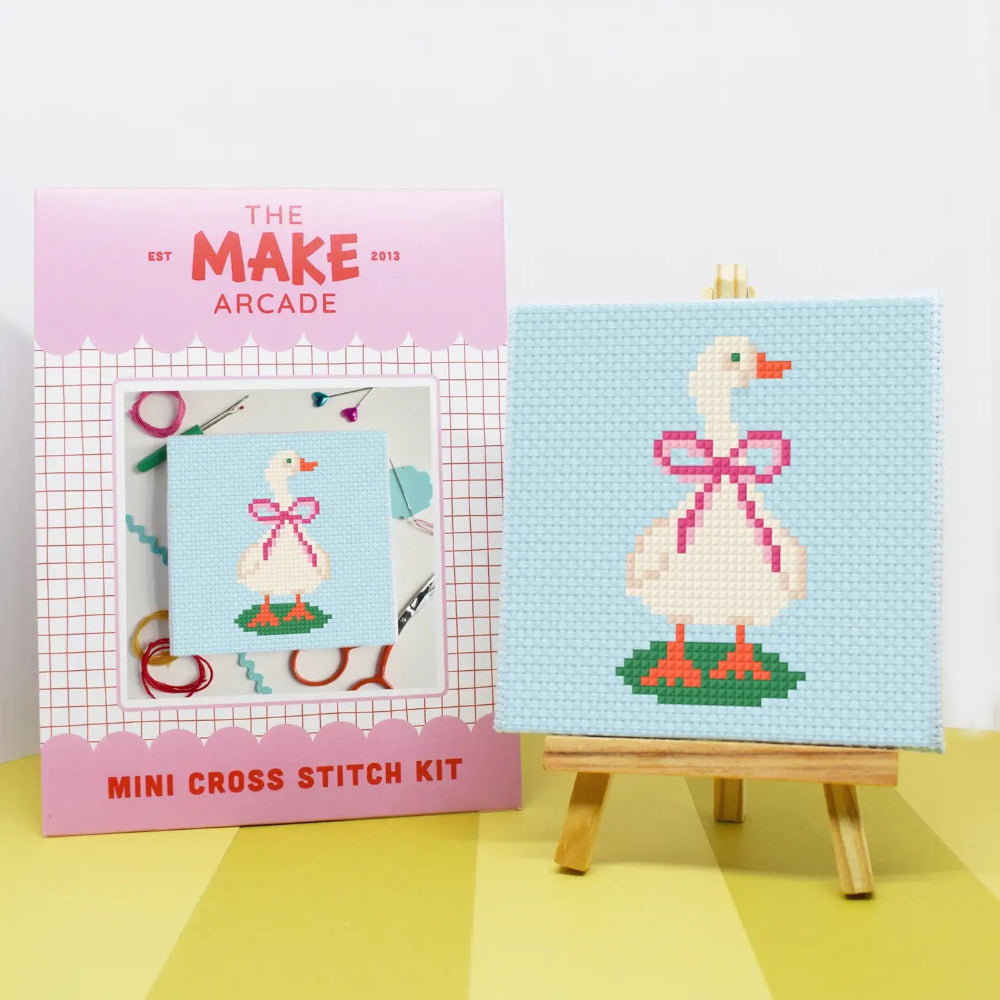 Make Arcade mini cross stitch kit with a completed cross stitch of a goose on a blue background.