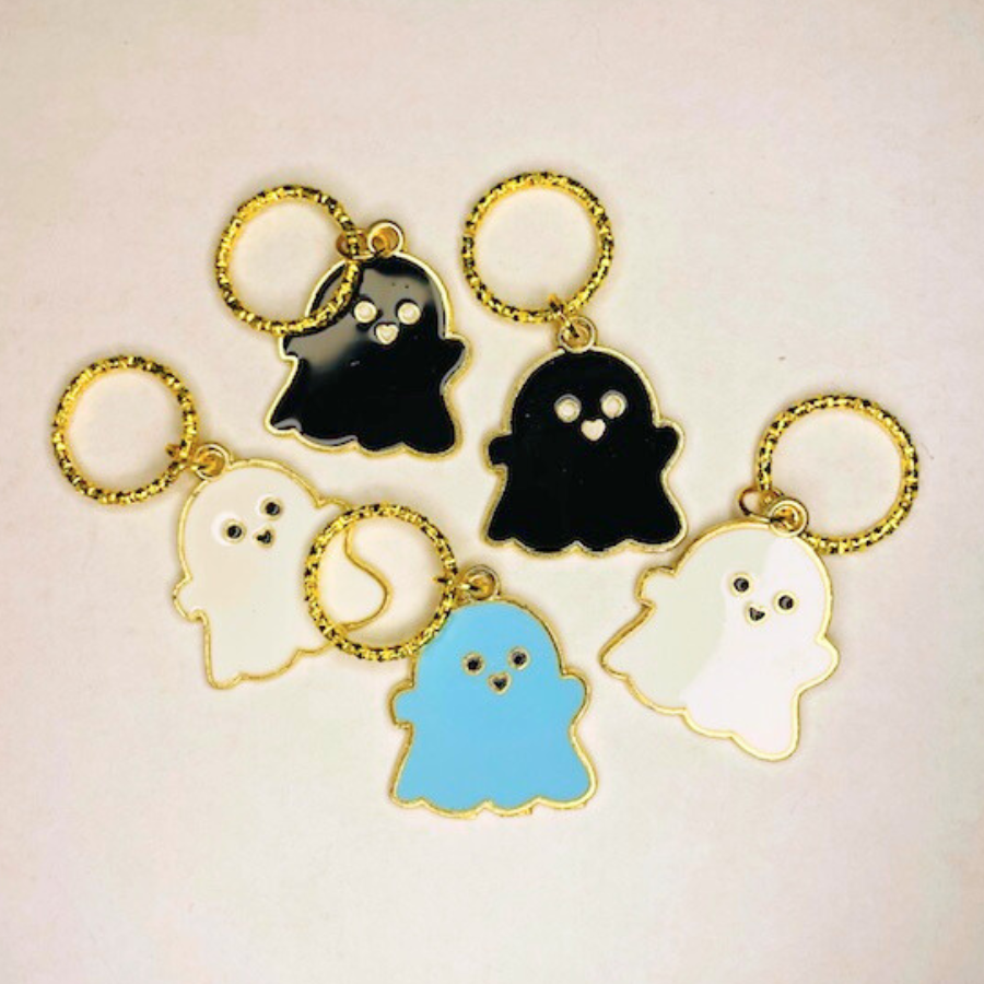 Ghost-shaped enamel and metal knitting stitch markers in assorted colors: white, blue, and black, with gold metal rings