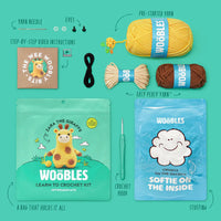 Woobles learn to crochet kit with yarn, hook, and packaging on a teal background