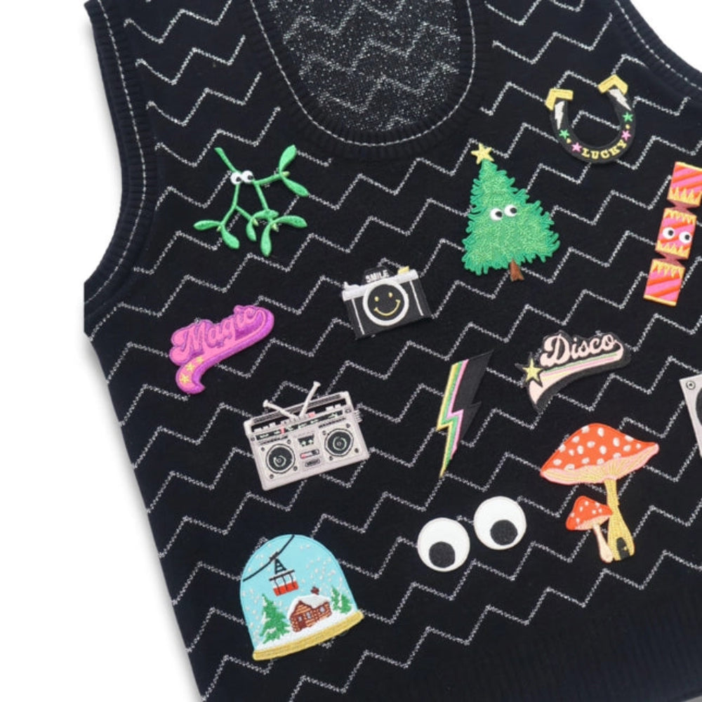 Black tank top with colorful patches including a camera, tree, disco ball, and mushroom.
