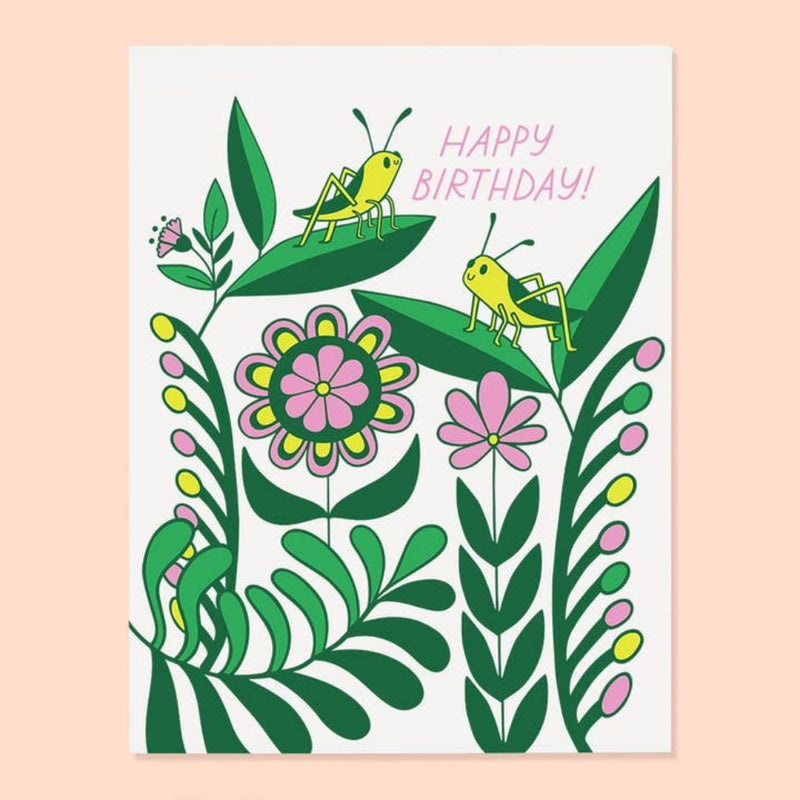 Two grasshoppers on leaves with green, pink, and yellow flowers on a white background with the text "Happy Birthday" in pink.